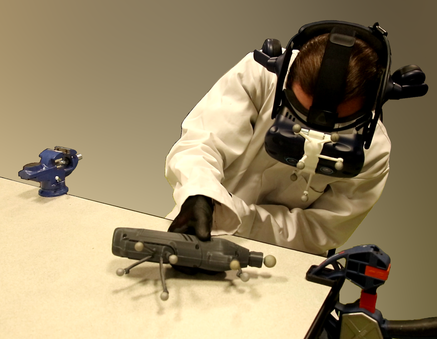 Participant using the tracked tool replica while wearing a virtual reality headset